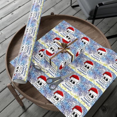 Gift wrap paper with a skull and Santa hat design on a starry background.