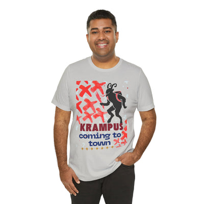 A man wears a light grey t-shirt with a Krampus graphic and text.