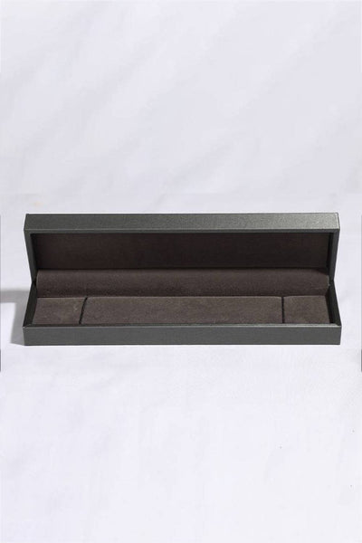 A dark gray, open jewelry box with a brown velvet interior.