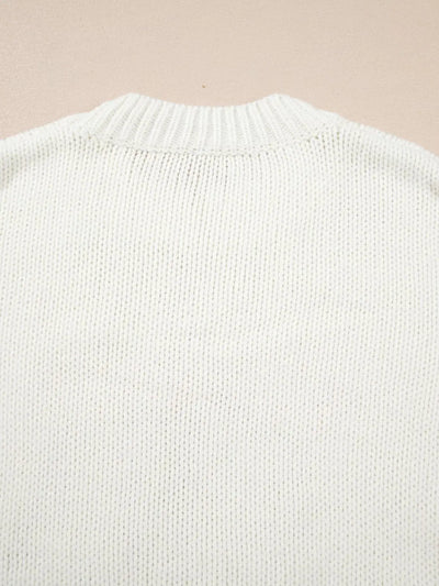 White knit sweater with a ribbed neckline.
