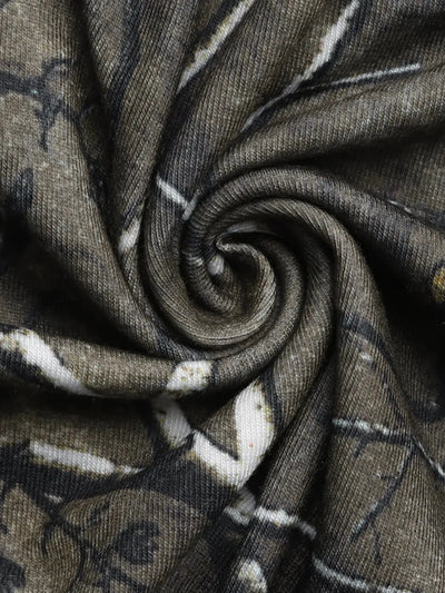 Asymmetrical long sleeve top with a camouflage print and cutout detail.