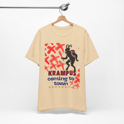 A tan t-shirt with a black silhouette of Krampus and the text "Krampus coming to town".