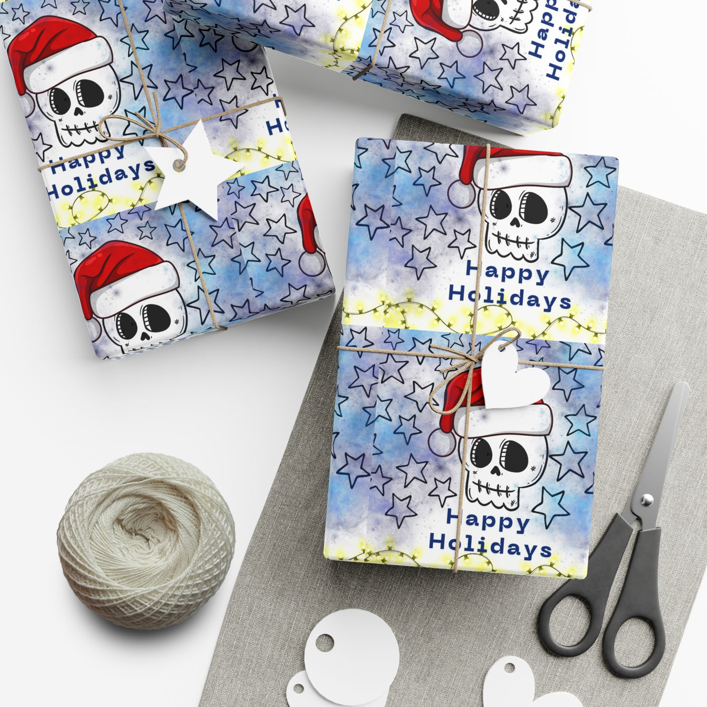 Gift wrap with a skull wearing a Santa hat and stars on a blue background.