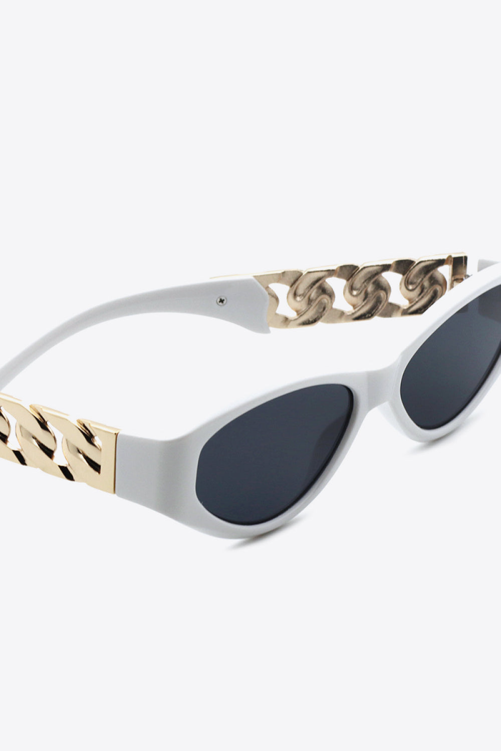 White cat eye sunglasses with gold chain detail on the temples.
