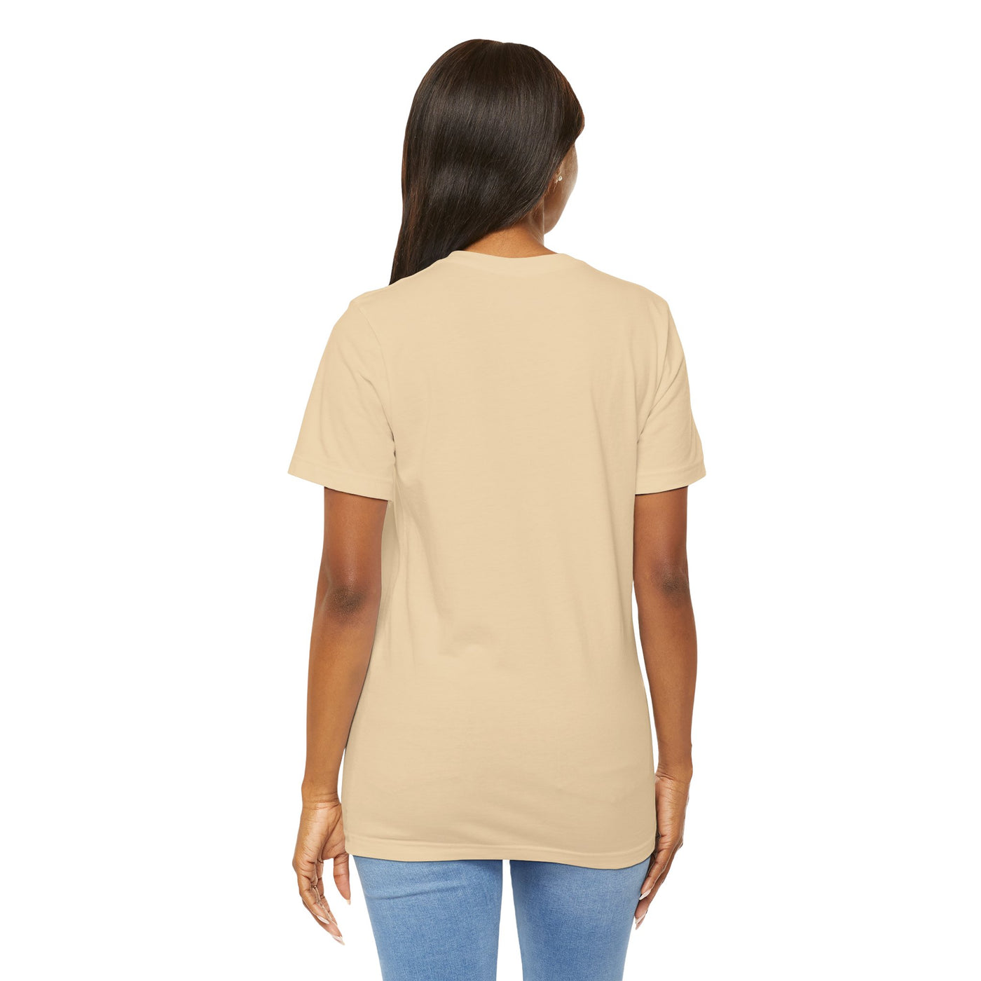 Back view of a woman wearing a tan t-shirt and blue jeans.