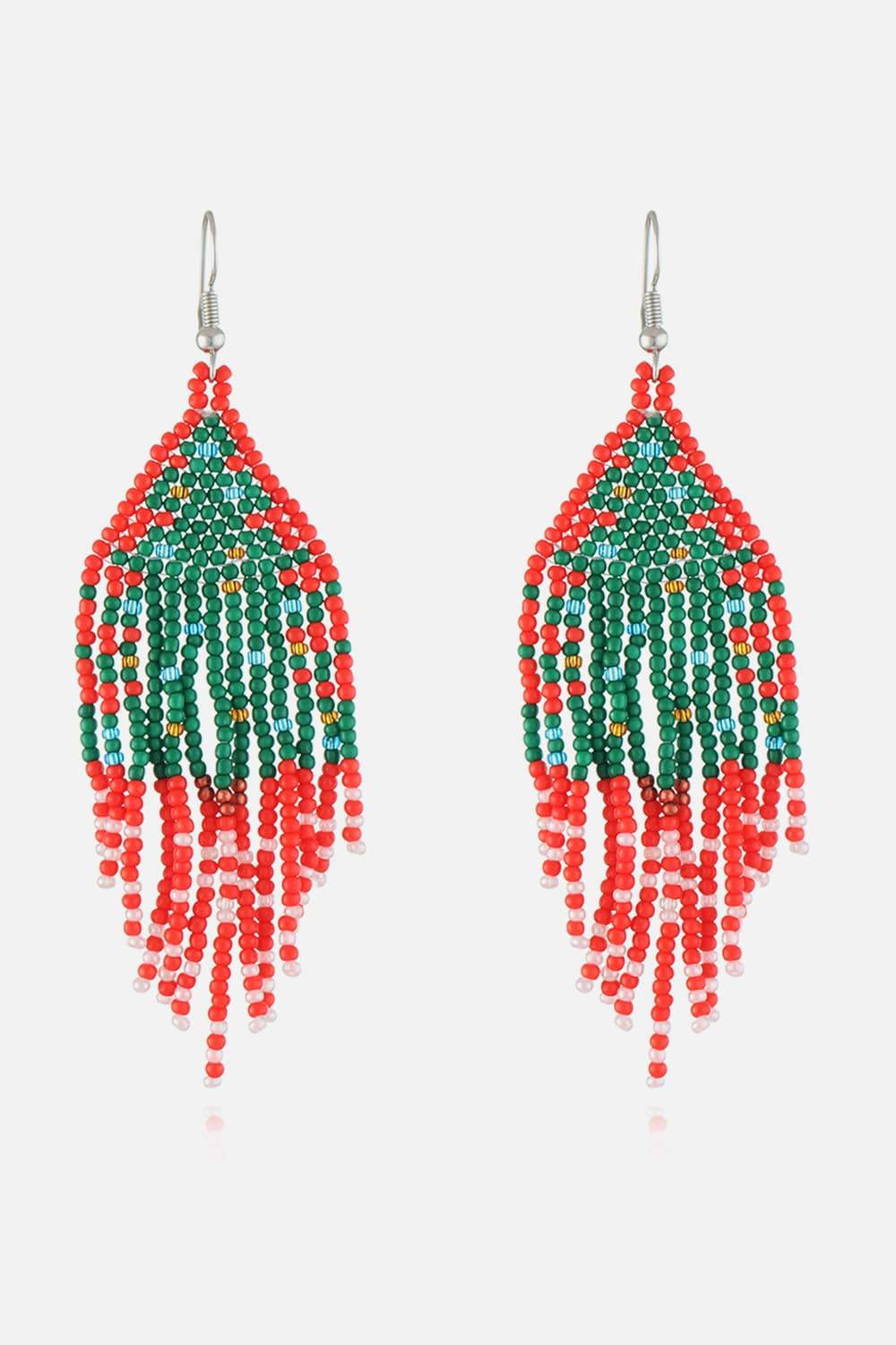 Handmade beaded earrings in red, green, and white with a Christmas design.
