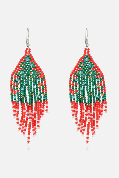 Handmade beaded earrings in red, green, and white with a Christmas design.