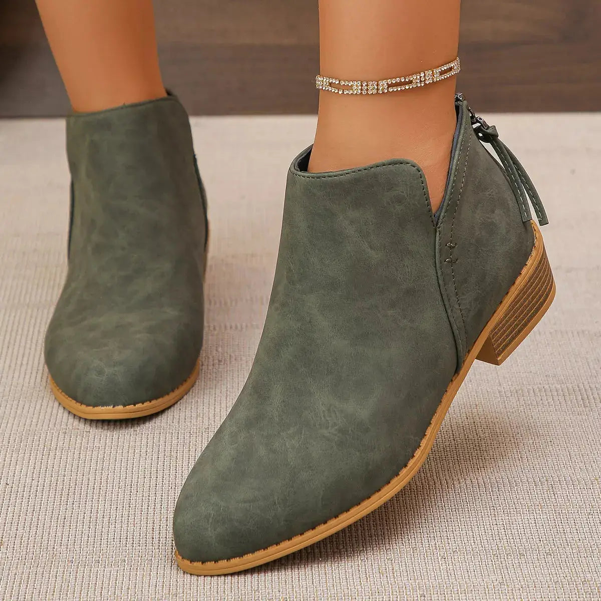 Pointed toe PU leather block heel booties with a side zipper.