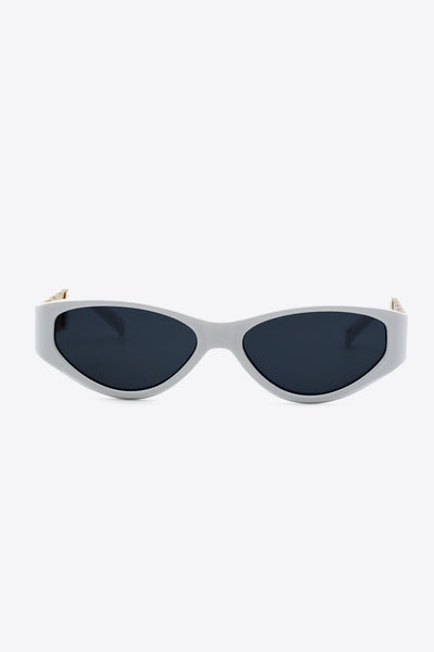 White cat-eye sunglasses with dark lenses and chain detail on the temples.
