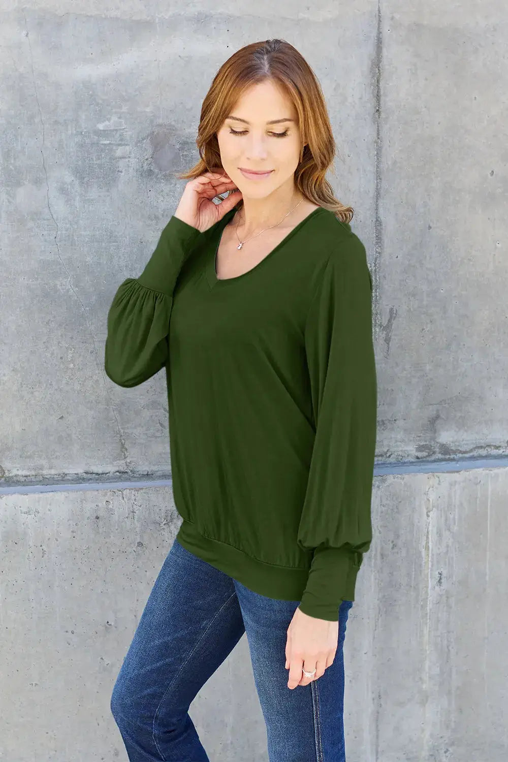 Women's olive green v-neck top with lantern sleeves.