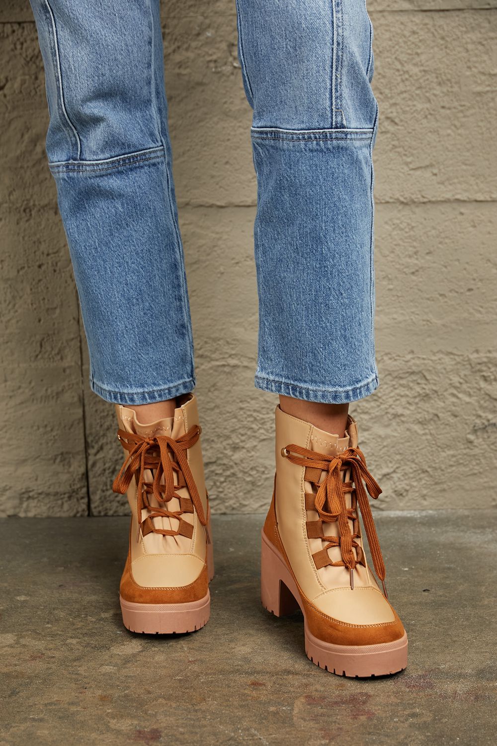 Tan and brown faux leather lace-up block heel booties.