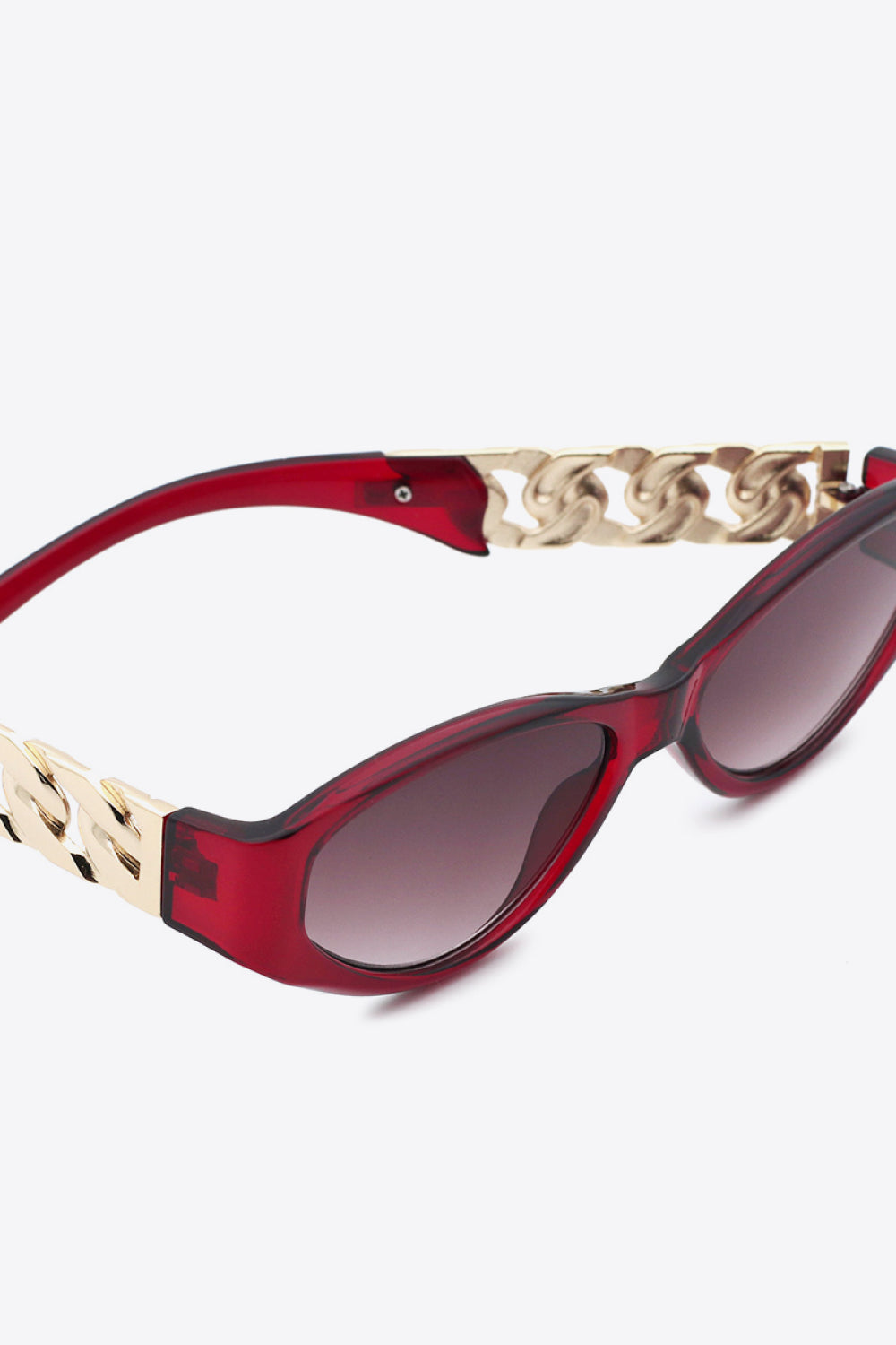 Red cat-eye sunglasses with gold chain detail on the temples.