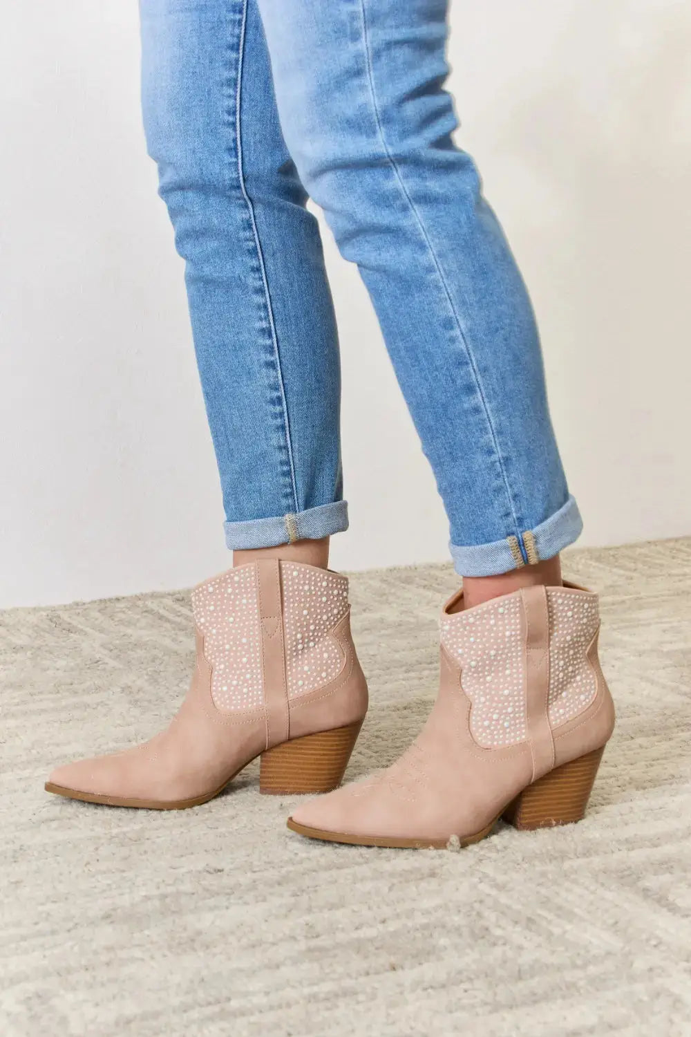 Pink rhinestone cowgirl booties with mid heels.