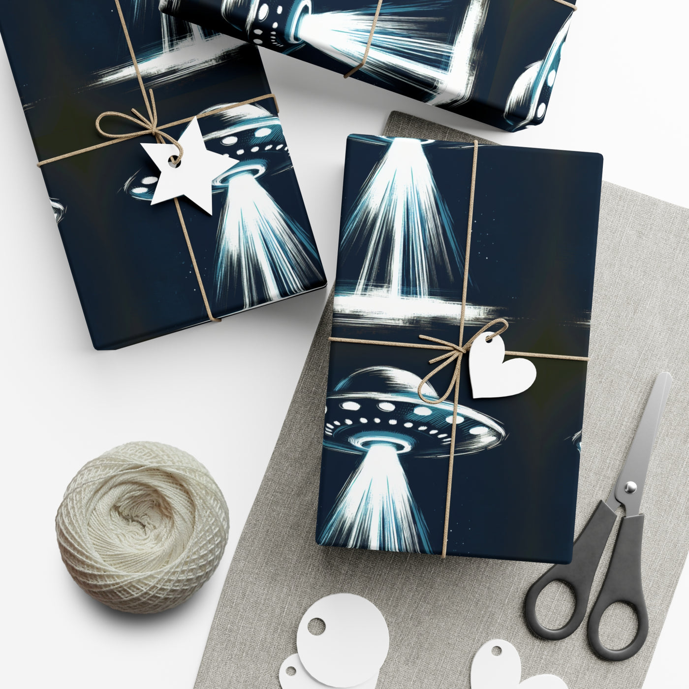 Wrapping paper with a dark blue background featuring a repeating pattern of white and blue UFOs with light beams.
