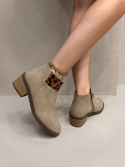 Beige suede ankle boots with leopard print detail and block heels.