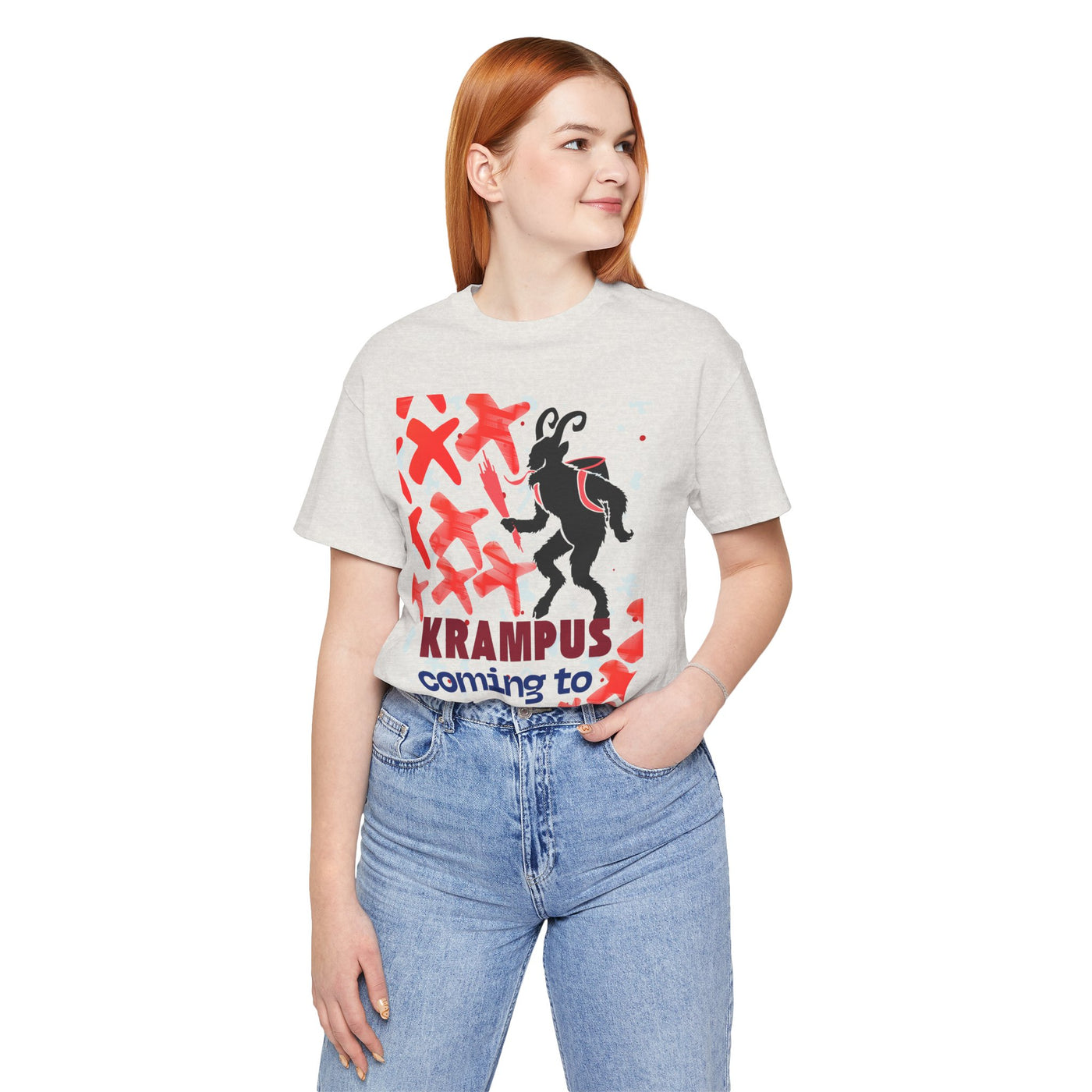 A woman wears a light grey t-shirt with a Krampus graphic and text.