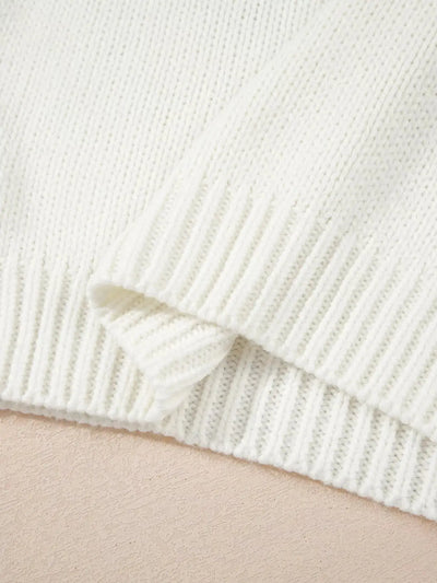 A white knit sweater with ribbed cuffs and hem.