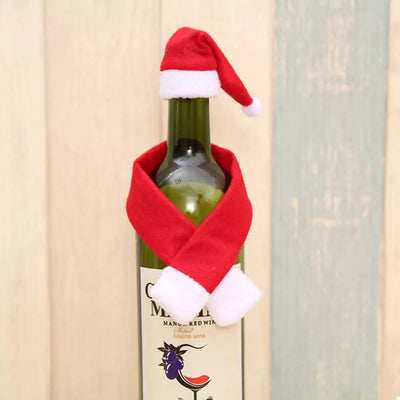 Christmas wine bottle covers with a Santa hat and scarf.