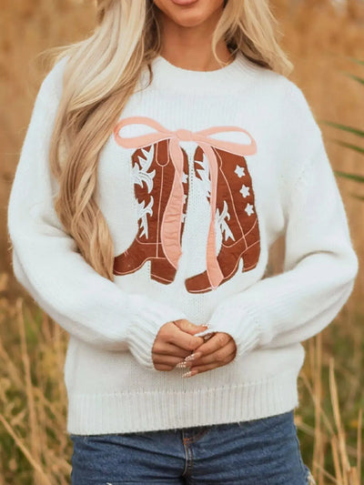 White drop shoulder sweater with embroidered cowboy boots and pink bow detail.