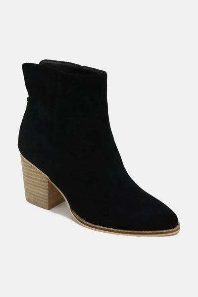 Black suede ankle booties with a pointed toe and wooden block heel.