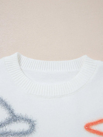 White knit sweater with a crew neck and sparkly embellishments.