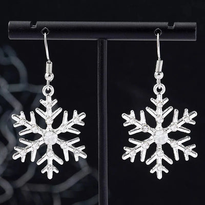 Silver-plated snowflake dangle earrings with rhinestones.