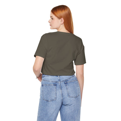 Back view of a woman wearing a dark olive green t-shirt and light wash denim jeans.