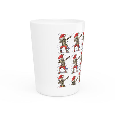 Ceramic shot glass with a repeating pattern of skeletons wearing Santa hats.