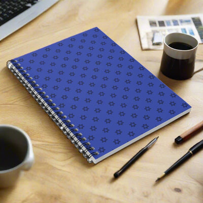 Blue spiral notebook with a repeating star pattern.