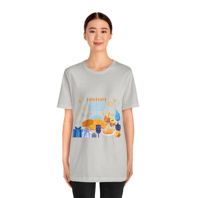 Light grey t-shirt with a colorful Hanukkah graphic featuring a menorah, dreidels, gelt, and gifts.