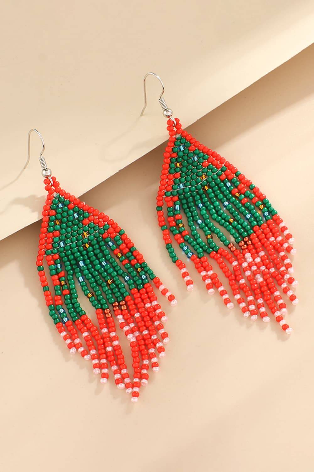 Red and green beaded fringe earrings with white accents.