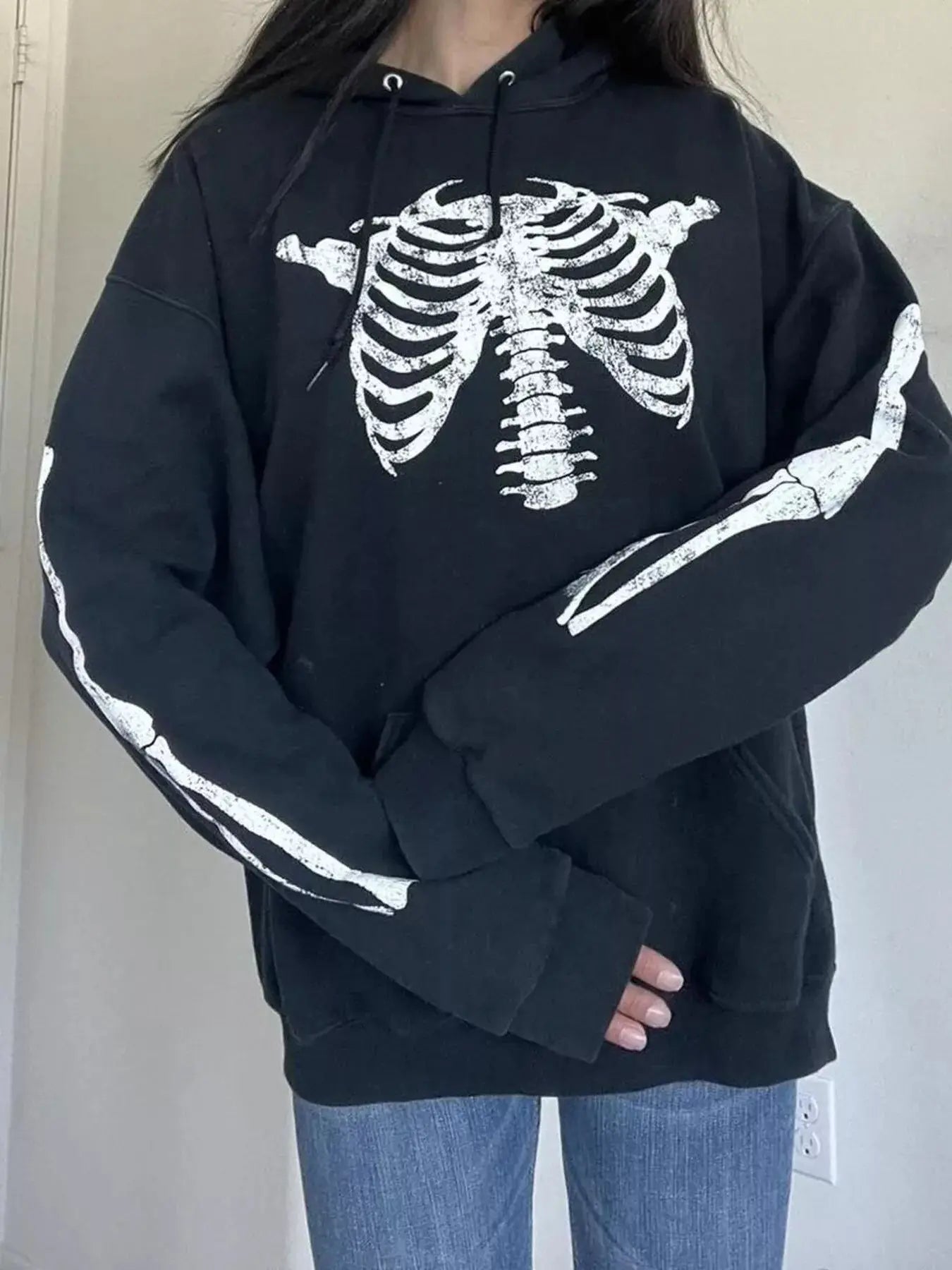 Black long sleeve hoodie with a white skeleton print.