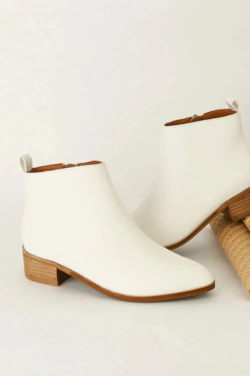 White PU leather ankle boots with a low block heel.