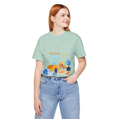 Light green t-shirt with a graphic of Hanukkah symbols.