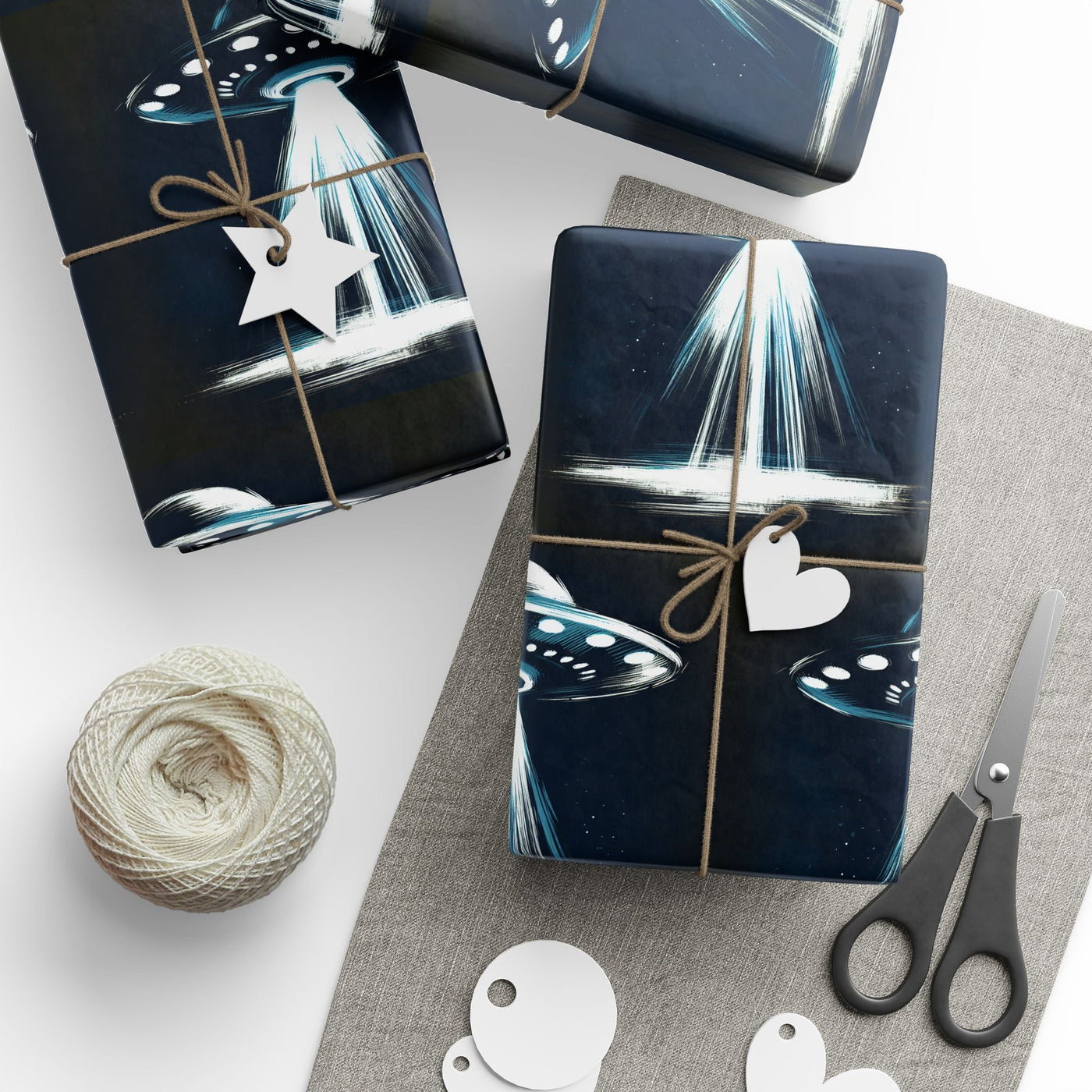 UFO-themed wrapping paper with a beam of light and a gift tag.