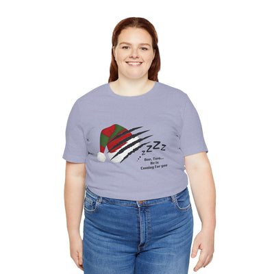 A woman wears a light purple t-shirt with a Nightmare on Elm Street graphic.