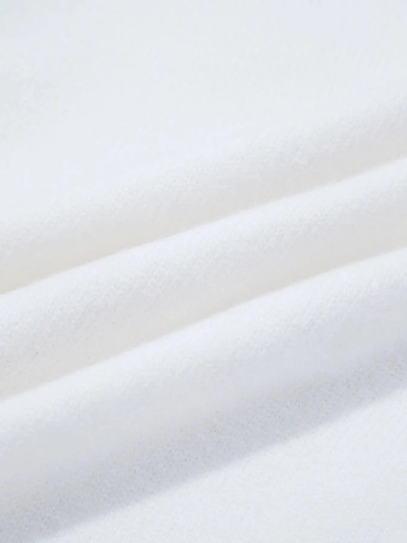White knit fabric with soft folds.