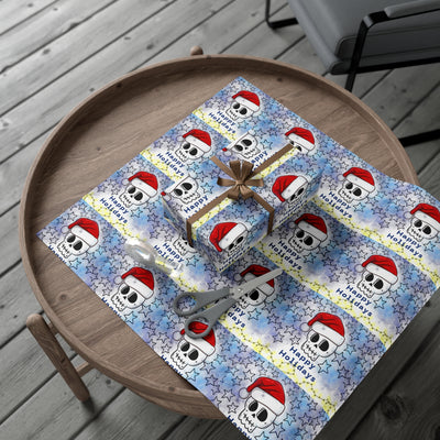 Gift wrap paper with a repeating pattern of skulls wearing Santa hats and stars.