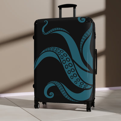 Durable suitcase with teal kraken design and 360-degree wheels, shown in sunlit room for stylish travel.