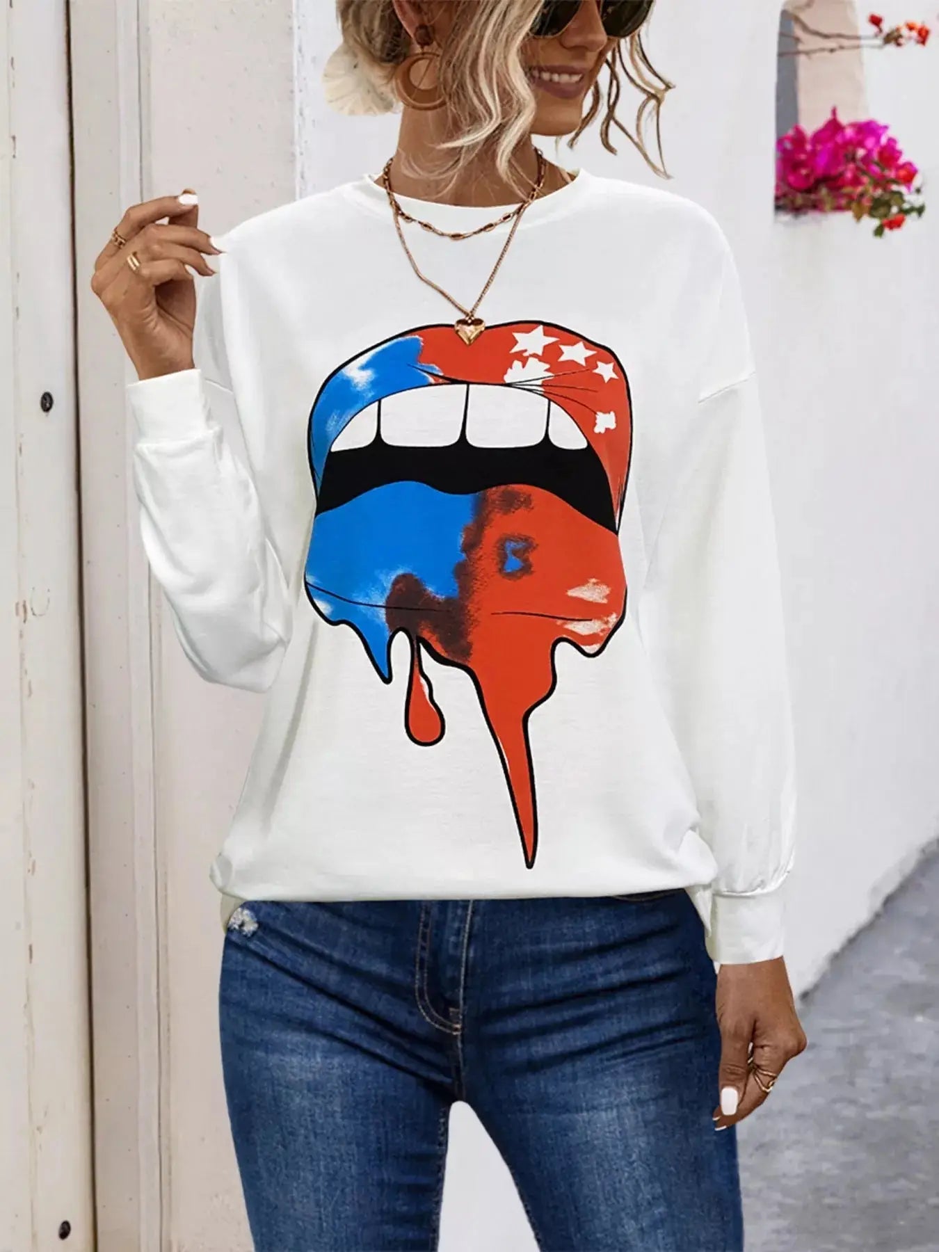 White graphic t-shirt with a dripping red, white, and blue lips design.