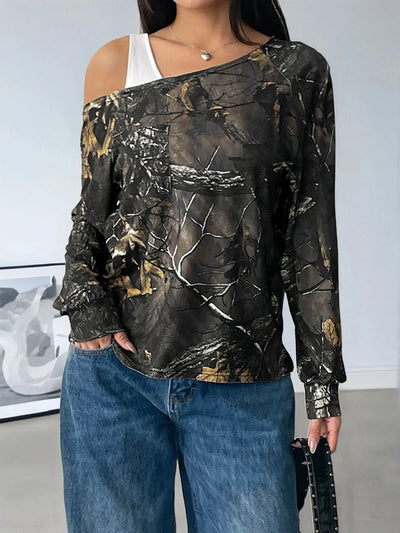 Asymmetrical long sleeve top with a camouflage print and cutout detail.