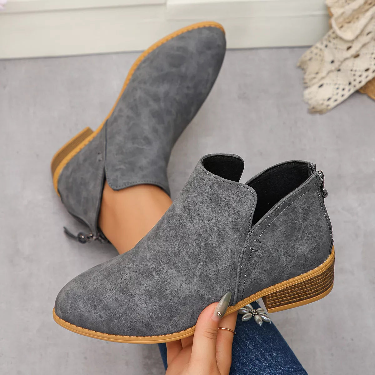 Grey PU leather pointed toe block heel booties with side cutouts and back zipper.