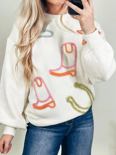 White knit sweater with western boot and horseshoe embroidery.
