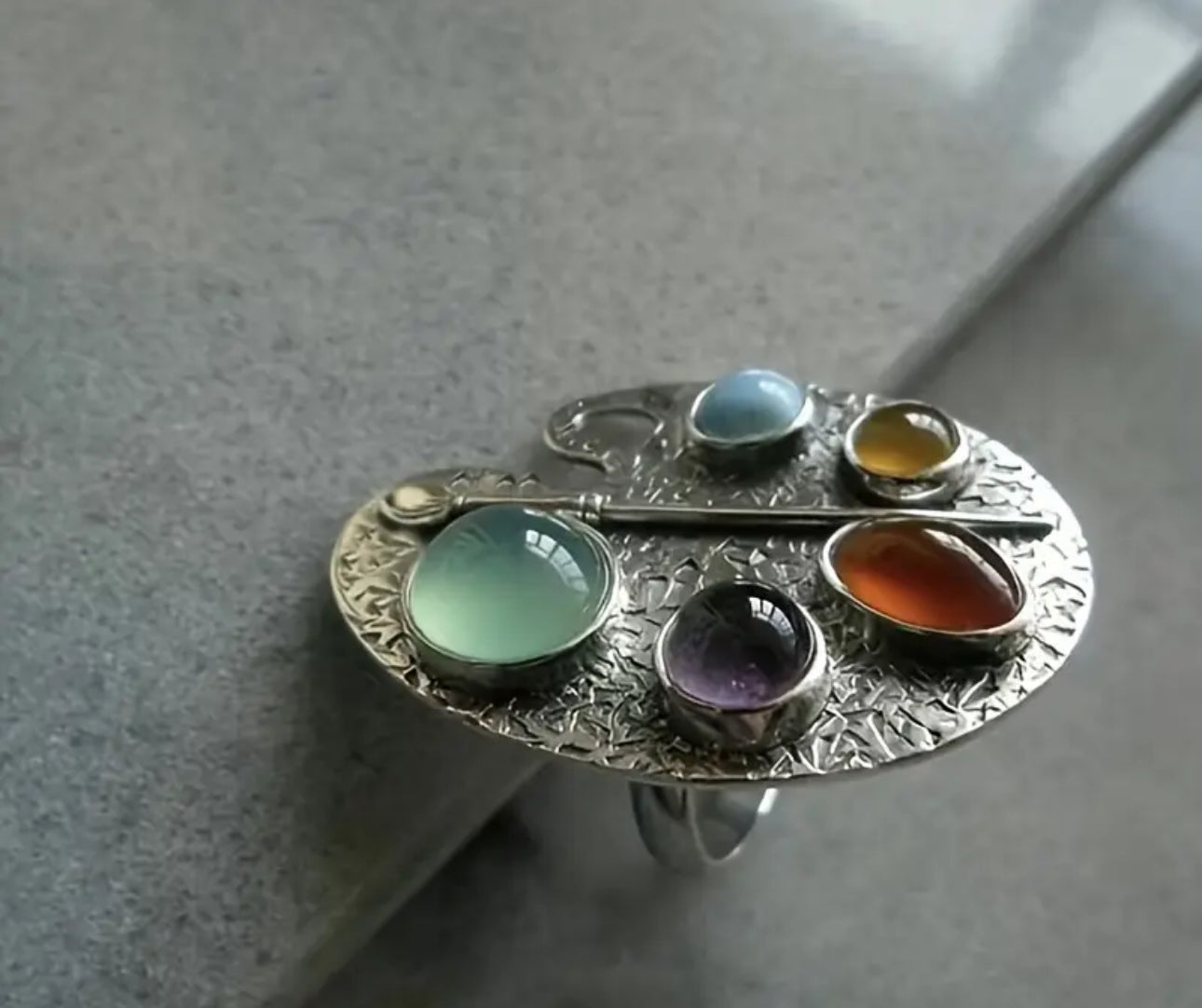 Colorful Paint by Gem Artist Ring with vibrant gemstone accents in a palette-inspired design, perfect for creative fashion lovers.


