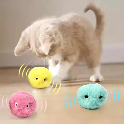 Cute grey cat playing with an interactive smart catnip plush toy on a wooden floor

