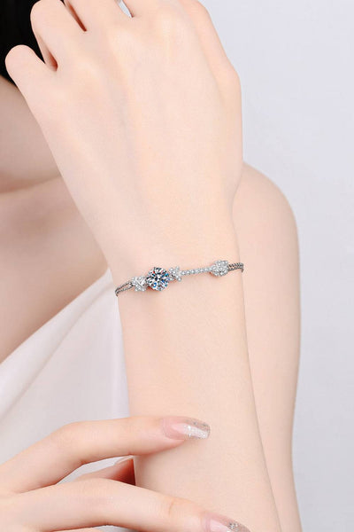 A minimalist moissanite bracelet on a woman's wrist.