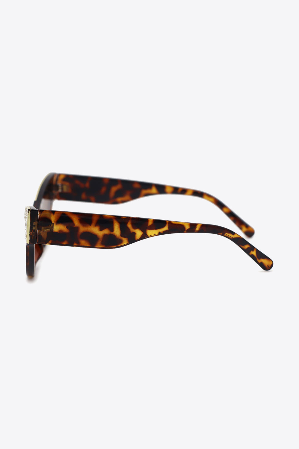 Tortoiseshell cat-eye sunglasses with rhinestone trim.
