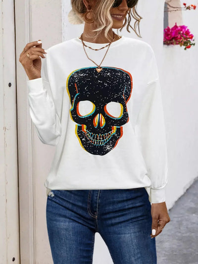 White long-sleeve t-shirt with a colorful skull graphic.