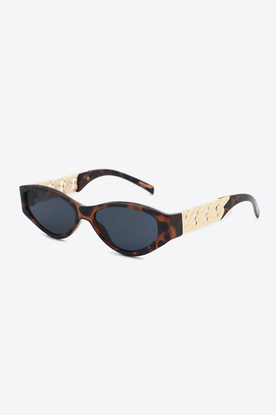 Cat eye sunglasses with tortoise shell frames and gold chain detail.