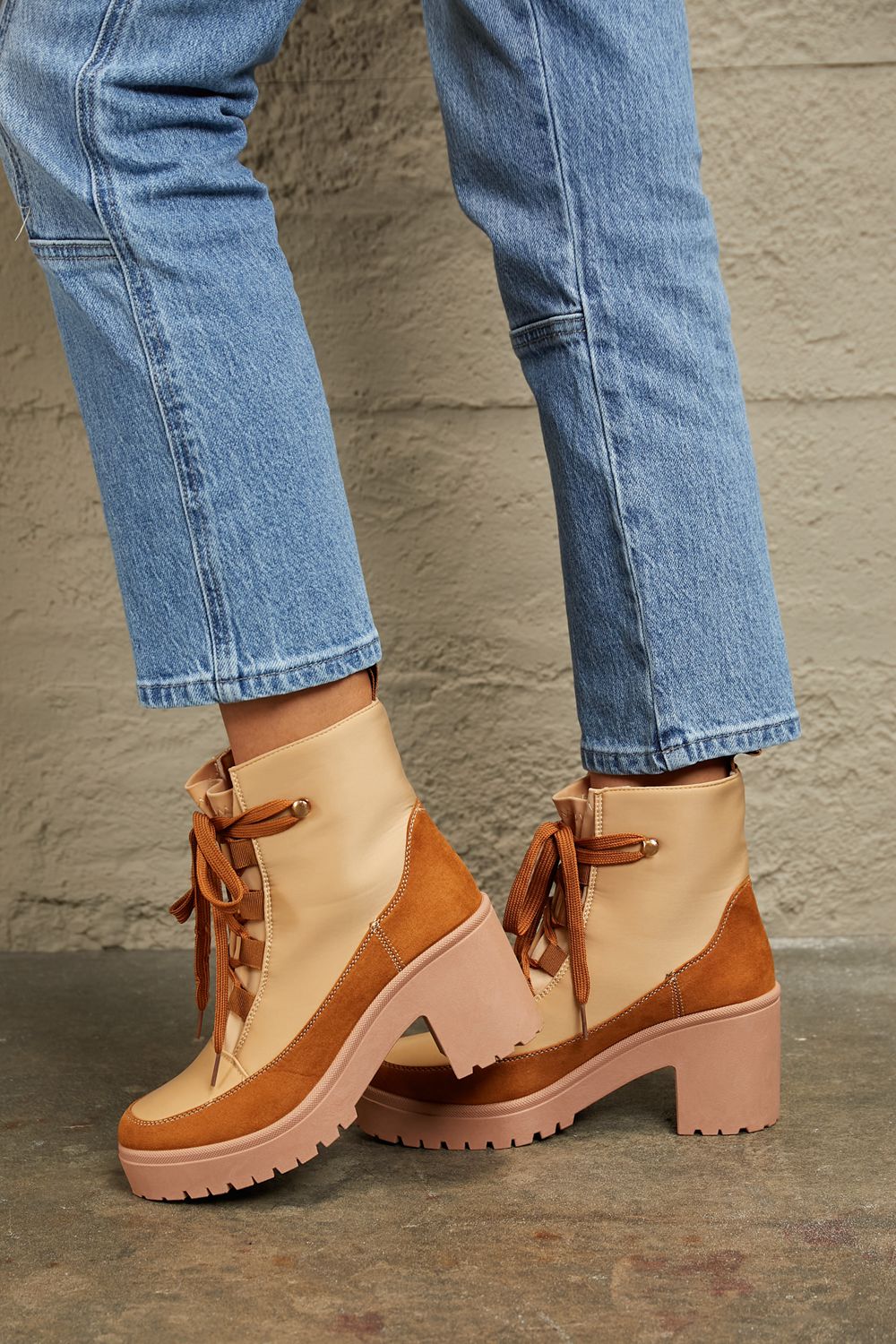 Tan and brown faux leather block heel booties with laces.